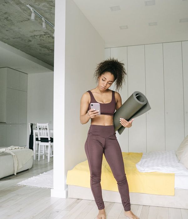 Woman feeling energized and balanced in a bright, minimalist space.